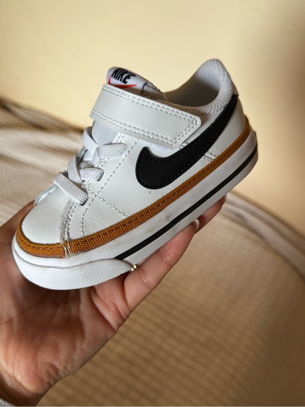 Nike Kids White Sneaker with Black Swoosh and Brown Trim
